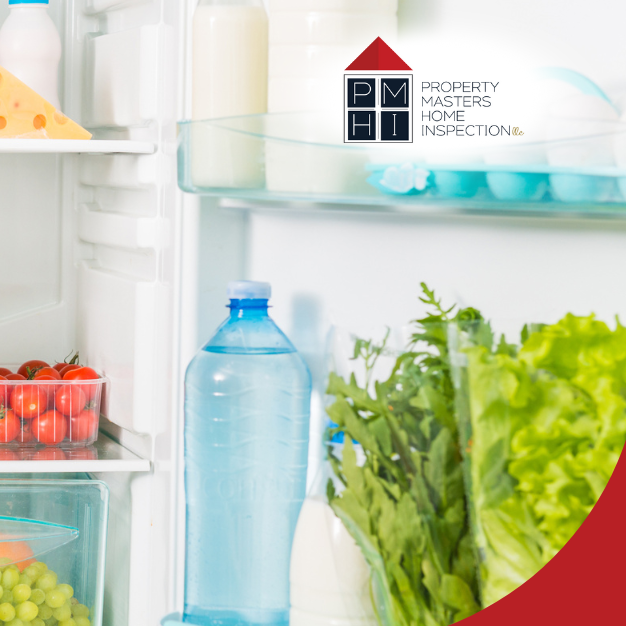 Refrigerator shelf with bowls of grapes, plums, tomatoes, and other fresh produce.