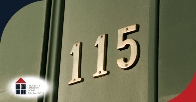 Gold house number 115 on a green door