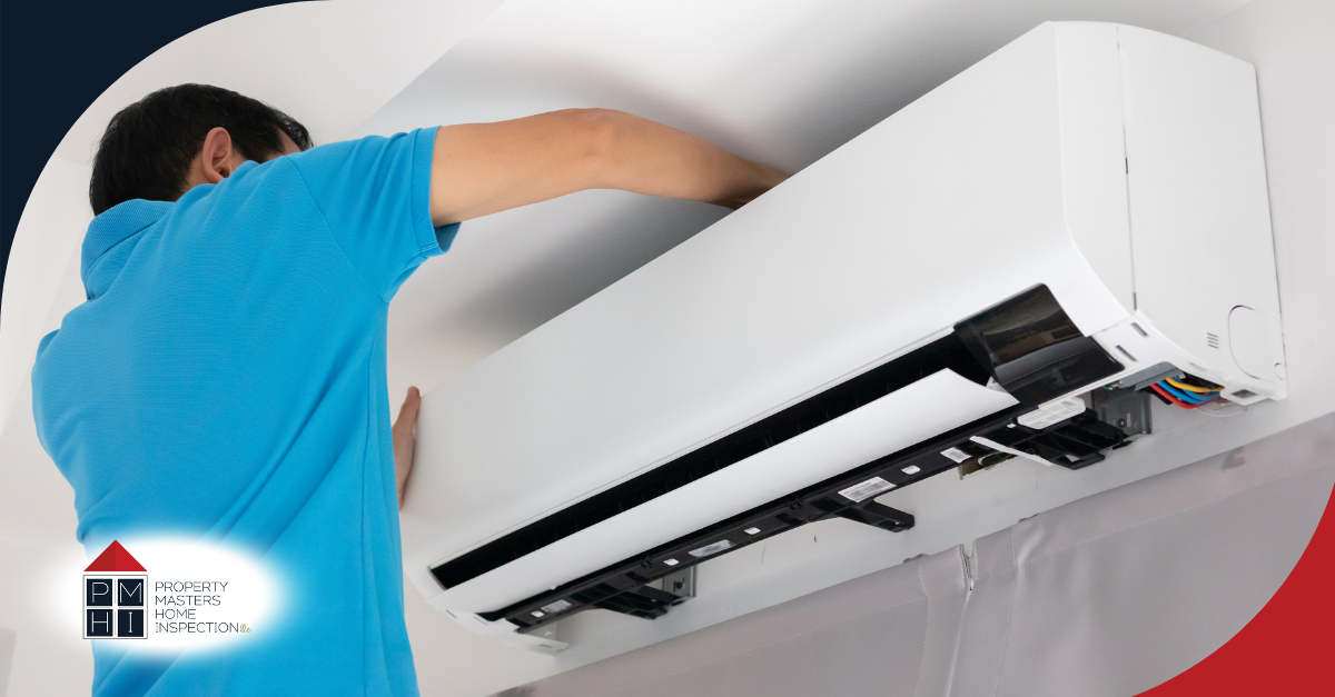 Technician inspecting wall-mounted AC unit