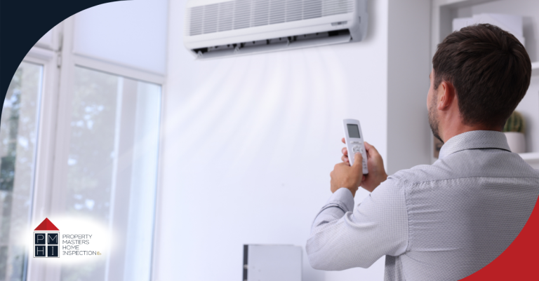 Man adjusting indoor air conditioning unit.